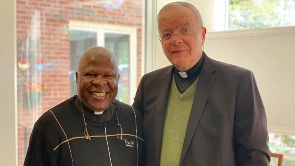 Father Joe Kakooza (left), of the Kasana-Luweero Diocese, and Monsignor Michael Shugrue, of the Diocese of Raleigh, work together for wells and school lunches in Uganda.