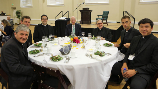 Clergy sit at the head table at St. Michael Church in Cary, where Father Robert Spitzer, S.J., presented "The Four Levels of Happiness."
