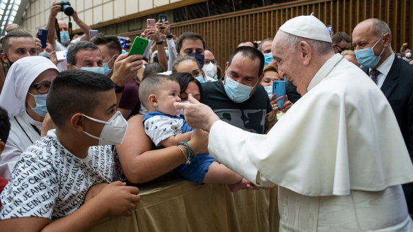 Pope Francis greets a child during his general audience in the Vatican's Paul VI hall Aug. 11, 2021. The pope continued his series of audience talks focused on St. Paul's Letter to the Galatians and reflected on what role God's law to Moses plays in helping people encounter Christ. (CNS photo/Vatican Media)