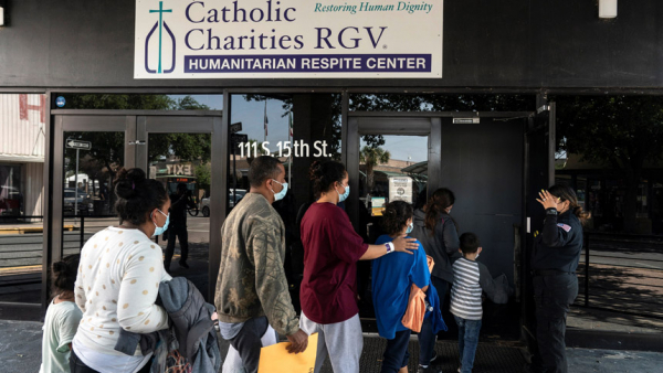 Migrants seeking asylum in the U.S. walk into a temporary humanitarian respite center run by Catholic Charities of the Rio Grande Valley in McAllen, Texas, April 8, 2021. (CNS photo/Go Nakamura, Reuters)