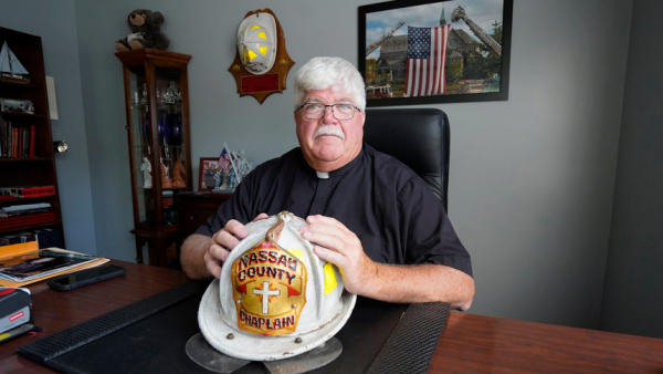 Father Kevin M. Smith, pastor of Our Lady of the Snow Parish in Blue Point, N.Y., is seen in his office Aug. 25, 2021. Father Smith, a Nassau County, N.Y., fire chaplain, served as a 9/11 first responder in the aftermath of the 2001 terrorist attacks in New York City. (CNS photo/Gregory A. Shemitz)