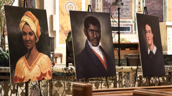 Portraits of three of six Black American Catholics who are sainthood candidates are seen at St. Matthew's Cathedral Feb. 6, 2022, during a Mass marking Black History Month.