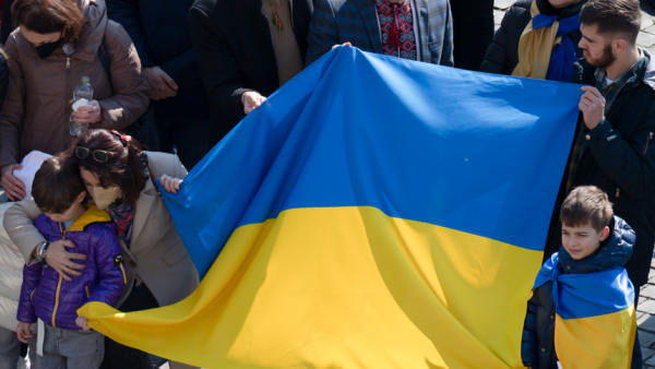 People hold Ukraine's flag in St. Peter's Square as Pope Francis leads the Angelus from the window of his studio overlooking the square at the Vatican March 6, 2022. In his Angelus message, the pope said the Vatican "is ready to do everything to put itself at the service of peace" in Ukraine. (CNS photo/Vatican Media)
