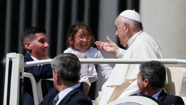 Pope Francis greets a child during his general audience in St. Peter's Square at the Vatican May 18, 2022. (CNS photo/Paul Haring)