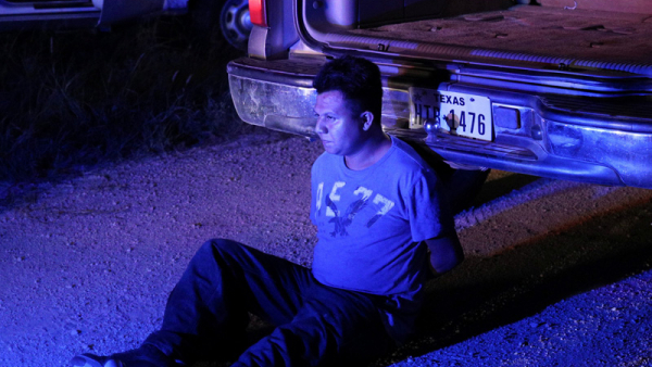 An undocumented man from Mexico is apprehended by Border Patrol agents near Falfurrias, Texas, Aug. 16, 2018, after allegedly dropping off a group of migrants in an area known for human smuggling. On June 27, 2022, first responders discovered a truck with at least 46 people dead; the truck appeared to be part of a smuggling operation. (CNS photo/Loren Elliott, Reuters)