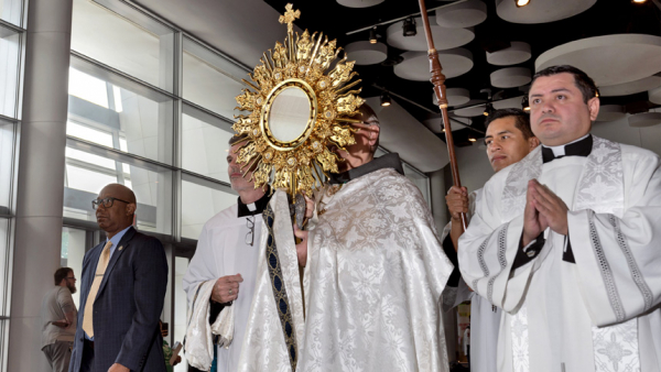 Archbishop Gregory J. Hartmayer of Atlanta carries the Blessed Sacrament at the the Georgia International Convention Center in College Park, Ga., June 18, 2022, on the last day of the archdiocese's 25th eucharistic congress. (CNS photo/Johnathon Kelso, The Georgia Bulletin)