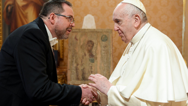 Pope Francis shakes hand with Ukraine's ambassador to the Holy See, Andrii Yurash, during a private audience at the Vatican April 7, 2022. After meeting with Pope Francis Aug. 6, Yurash said the pope planned on visiting the war-torn country before his visit to Kazakhstan in September. (CNS photo/Vatican Media via Reuters)