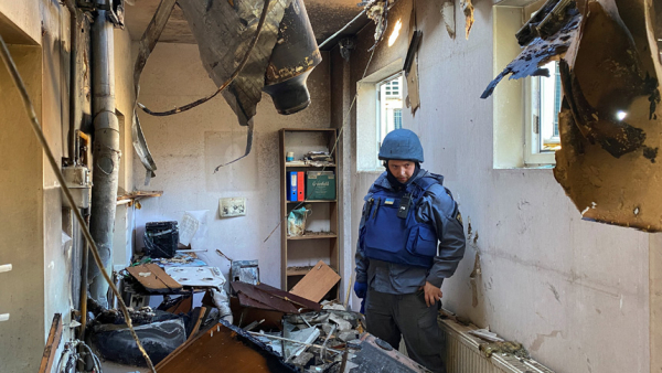  A demining specialist of the State Emergency Service stands next to a part of an intercepted Russian missile stuck in a residential building in Kharkiv, Ukraine, Oct. 8, 2022. (CNS photo/Vitalii Hnidyi, Reuters)