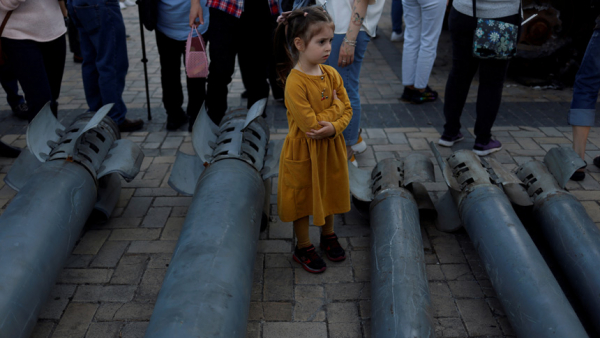 A girl looks on at a display of Russian weapon systems used in their attacks, outside St. Michael's Cathedral in Kyiv, Ukraine, May 29, 2022. During the month of November, Pope Francis is asking people to pray for children who are suffering because of poverty, war and exploitation. (CNS photo/Edgar Su, Reuters)