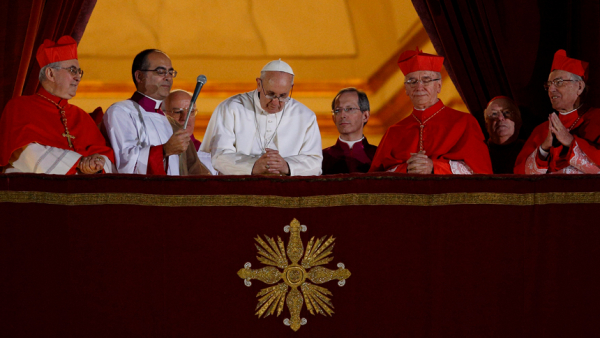 Pope Francis bows his head in prayer during his election night appearance on the central balcony of St. Peter's Basilica at the Vatican March 13, 2013. The crowd joined the pope in silent prayer after he asked them to pray that God would bless him. (CNS photo/Paul Haring)