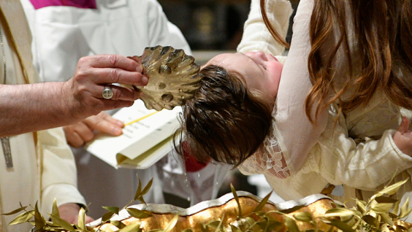Pope Francis baptizes a baby during a Mass in the Sistine Chapel at the Vatican in this file photo from Jan. 8, 2023. According to the Vatican's Statistical Yearbook of the Church 2021, the Catholic Church baptized 13.7 million people in 2021, more than 81% of whom were children under the age of 7. (CNS photoVatican Media)