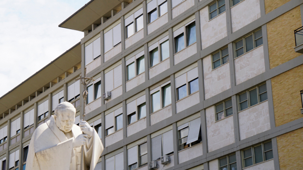 A statue of St. John Paul II is seen outside of Rome's Gemelli hospital June 8, 2023, where Pope Francis is staying in the papal suite on the top floor after undergoing surgery to treat a hernia June 7, 2023. (CNS photo/Justin McLellan)