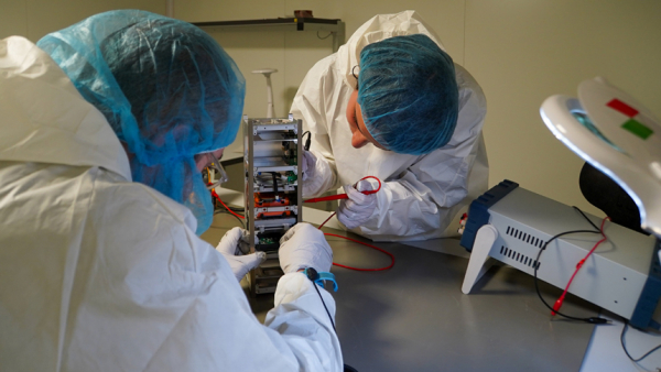 Students at the Polytechnic University of Turin work on "Spei Satelles," a small CubeSat satellite they built, which was launched into space June 12, 2023. The satellite carries a "nano" version of Pope Francis' book, "Why Are You Afraid? Have You No Faith?" It is also built to send signals back to earth for ham radio operators to hear the pope's messages of hope and peace. The "Spei Satelles" project is promoted by the Vatican Dicastery for Communication. (CNS photo/courtesy of Vatican Media)