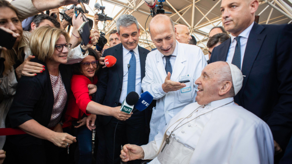 Pope Francis smiles as he leaves Rome's Gemelli hospital early June 16, 2023. Dr. Sergio Alfieri, the pope's chief surgeon, and Gianluca Gauzzi Broccoletti, commander of the Vatican police force, are next to the pope as he responds to questions from Spanish journalist Eva Fernández, left, and Italian journalist Vania De Luca. (CNS photo/Vatican Media)