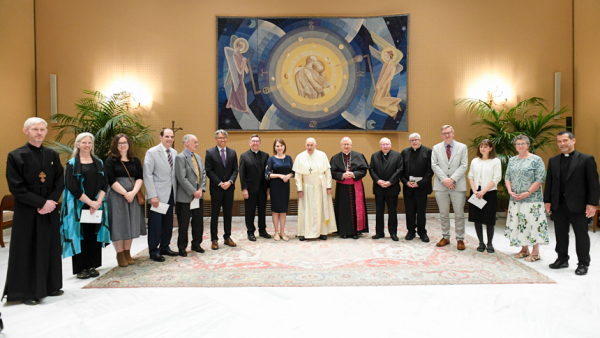 Pope Francis poses for a photo with members of the International Commission for Dialogue between the Disciples of Christ and the Catholic Church, including Monsignor Michael Clay of the Diocese of Raleigh (seventh from left) in a meeting room of the Vatican audience hall June 28, 2023. (CNS photo/Vatican Media)