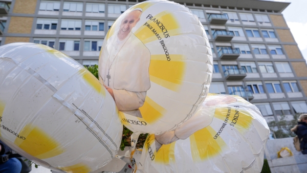 Balloons featuring an image of Pope Francis are seen outside Rome’s Gemelli hospital Feb. 27, 2025, while the pope is being treated there for double pneumonia. (CNS photo/Lola Gomez)