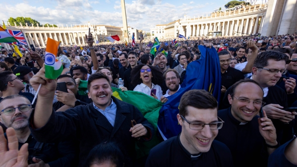 Crowds cheer in St. Peter's Square as white smoke emerges from the chimney atop the Sistine Chapel at the Vatican May 8, 2025, indicating Pope Leo XIV, the former Cardinal Robert F. Prevost, was elected pope. The new pope was born in Chicago. (CNS photo/Pablo Esparza)