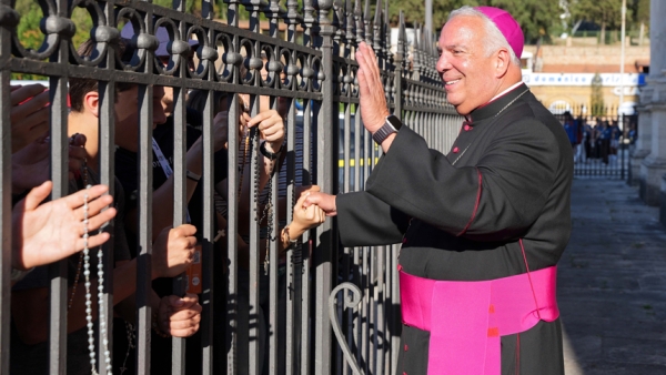 Archbishop Nelson J. Perez of Philadelphia greets young pilgrims who ask him to bless their rosaries outside the Basilica of St. Paul Outside the Walls in Rome before the USA National Jubilee Pilgrim Gathering July 30, 2025. The event was part of the Jubilee of Youth. (CNS photo/Lola Gomez)