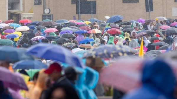 People shelter under umbrellas as rain falls near the end of Pope Leo XIV's weekly general audience in St. Peter's Square at the Vatican Sept. 24, 2025. (CNS photo/Pablo Esparza)