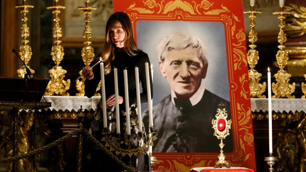 Melissa Villalobos of Chicago lights a candle during a vigil prior to the canonization of St. John Henry Newman at the Basilica of St. Mary Major in Rome, Oct. 12, 2019. Villalobos' healing through the intercession of St. John Henry Newman was accepted as the miracle necessary for the British cardinal's canonization. (CNS photo/Paul Haring)