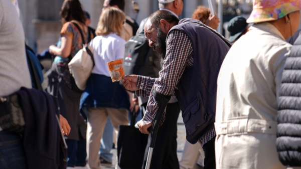 A person asks for alms near St. Peter’s Square at the Vatican Oct. 8, 2025. (CNS photo/Lola Gomez)