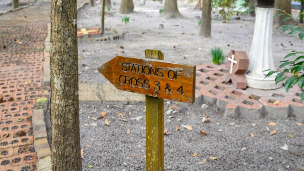 At St. Stanislaus in Castle Hayne, an outdoor wooden sign offers direction to those praying the Stations of the Cross. 